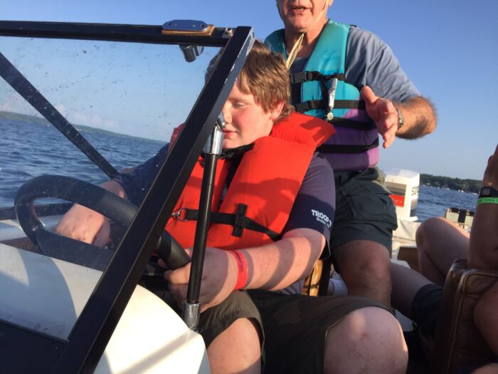 a scout learning to pilot a motor boat